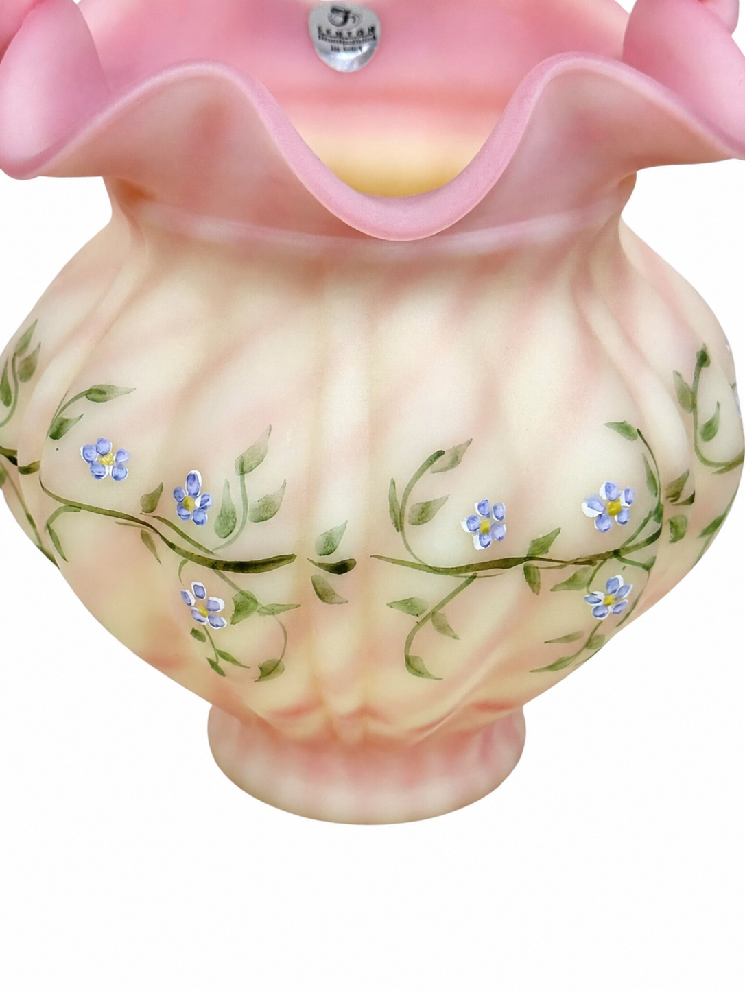 Collectible Fenton Burmese basket featuring delicate floral decoration and ruffled rim