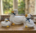 vintage white ceramic duck figurines set with blue bows