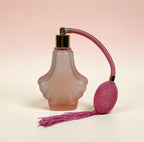 Vintage pink satin glass perfume bottle with atomizer puff