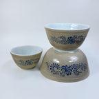 Retro Pyrex nesting bowls with blue floral folk art pattern