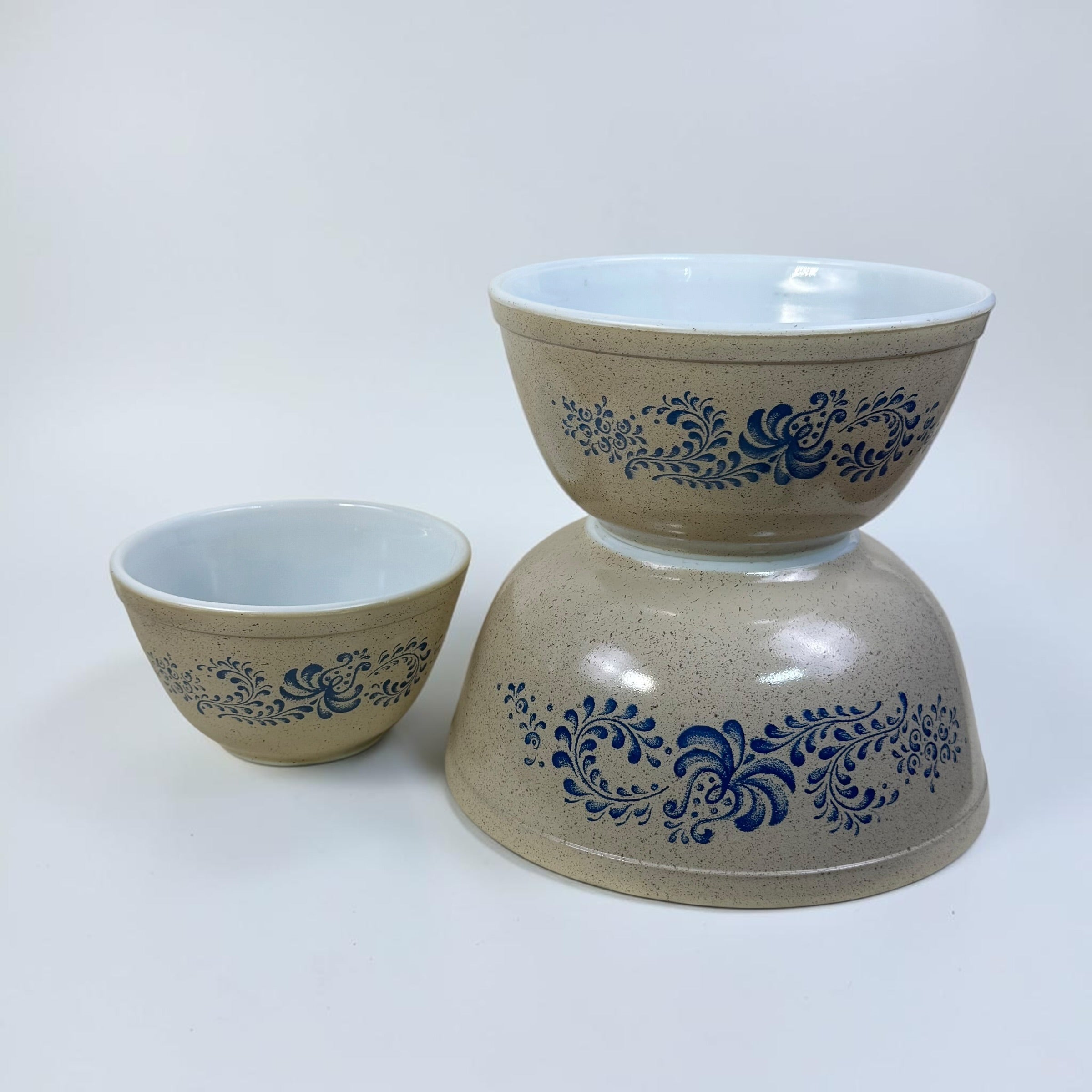 Retro Pyrex nesting bowls with blue floral folk art pattern