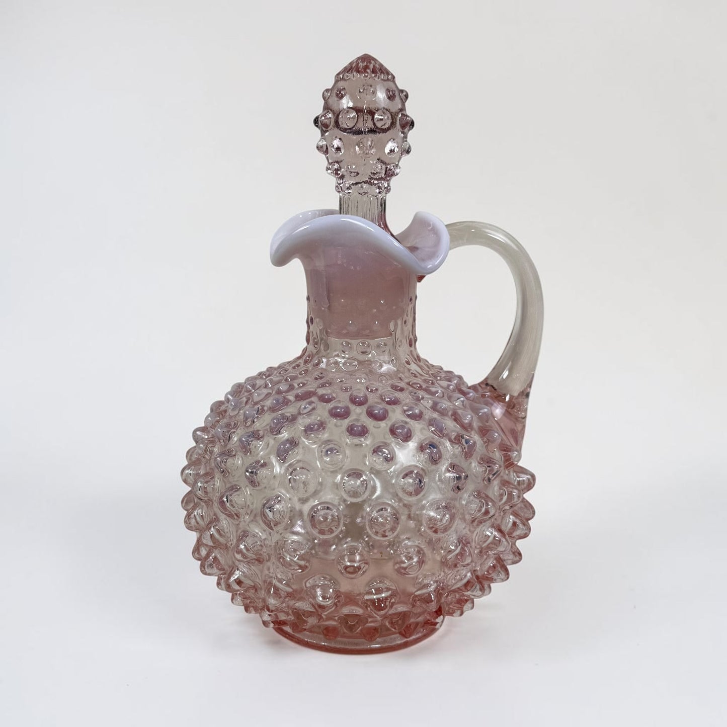 Vintage Fenton pink hobnail glass cruet with elegant handled design