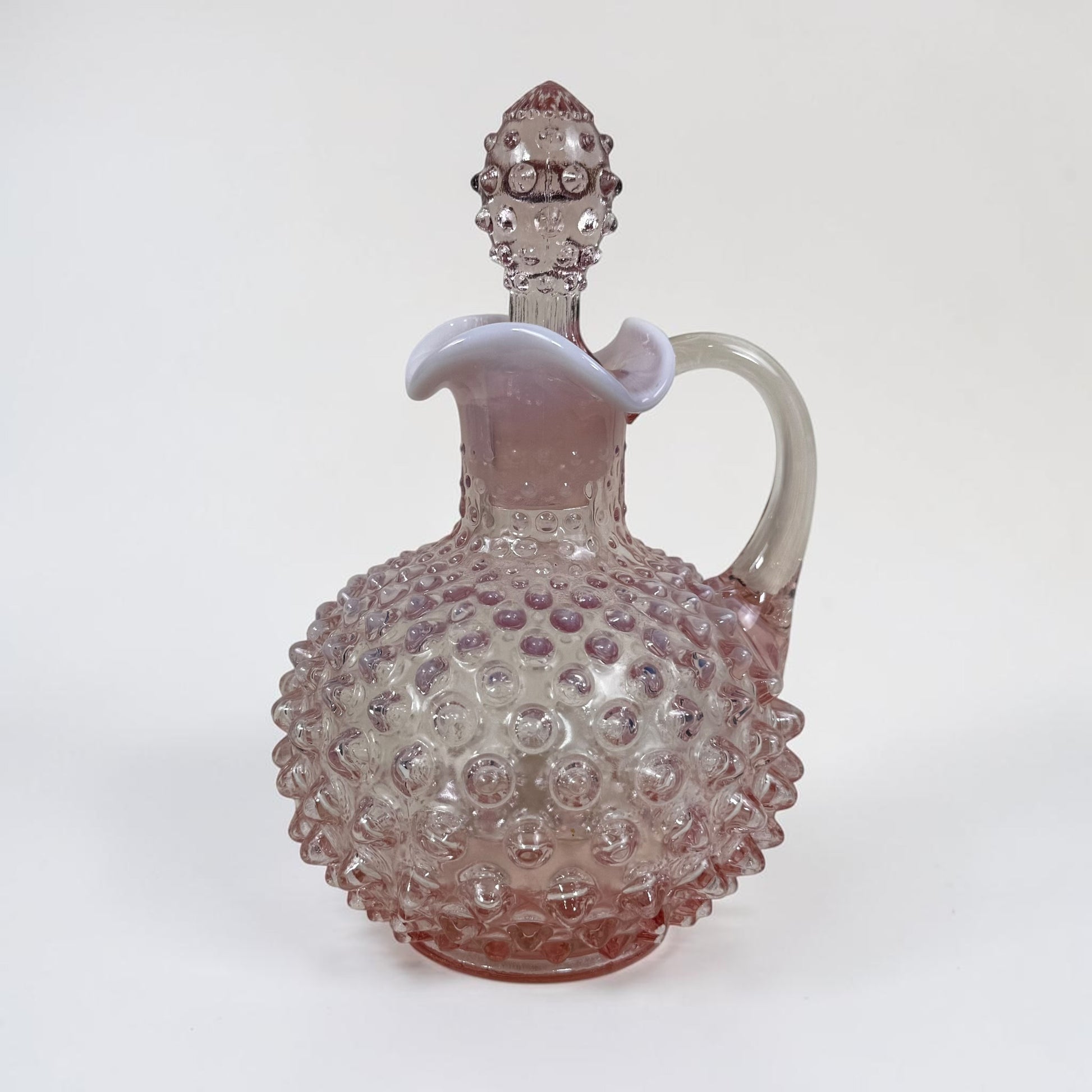 Vintage Fenton pink hobnail glass cruet with elegant handled design