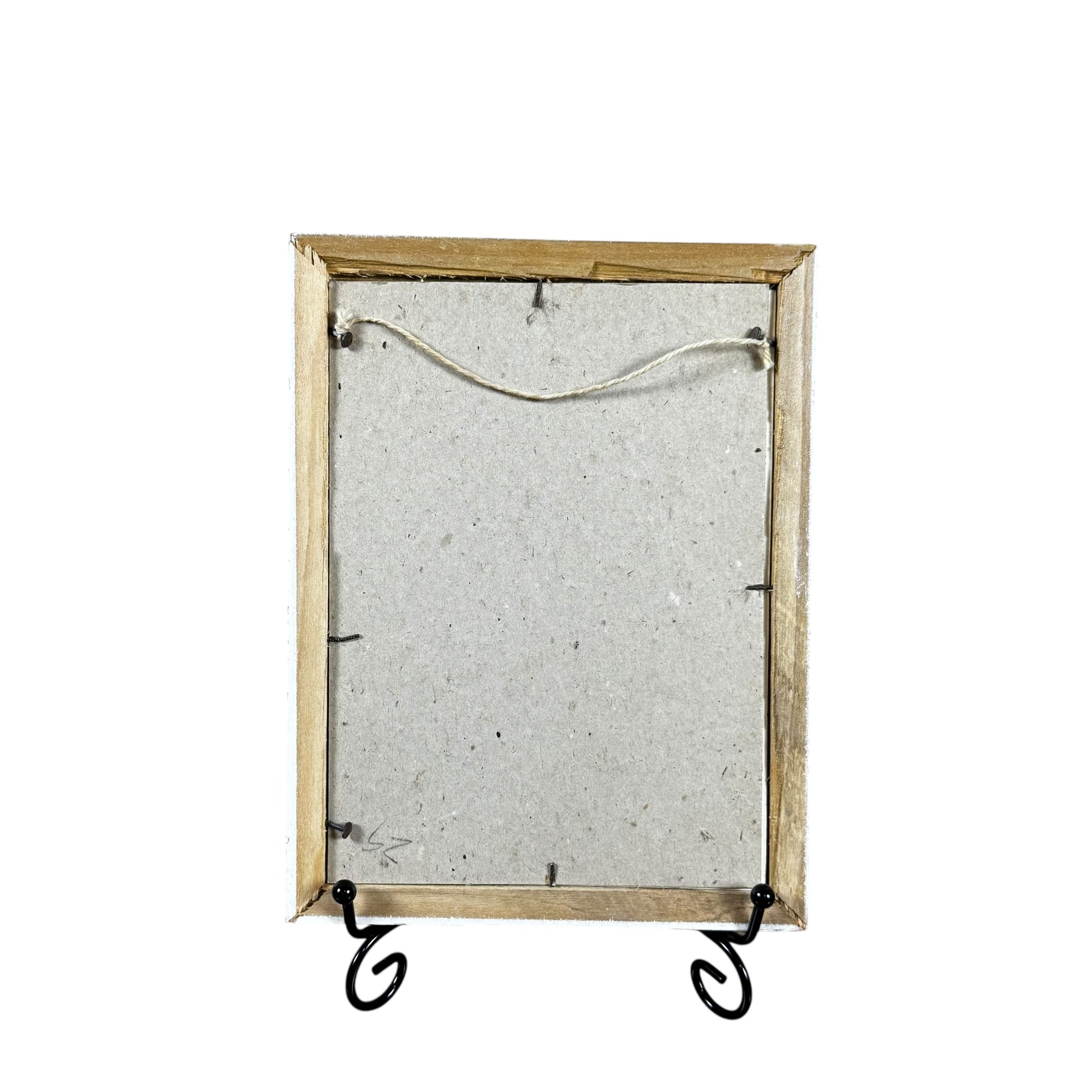 Decorative mirror with wooden frame and metal stand on a white background