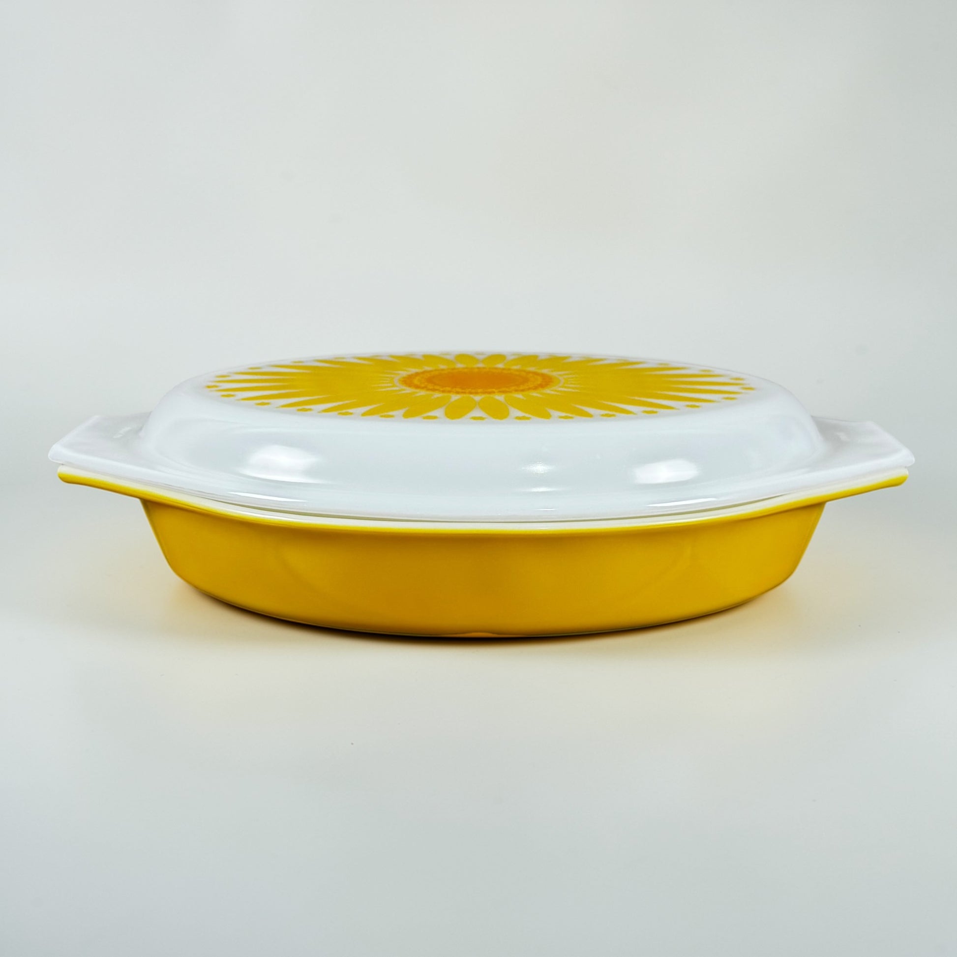 Vintage Pyrex Daisy yellow casserole dish with sunflower lid