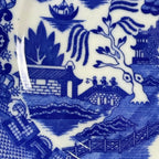 Blue and white ceramic tile with intricate design of a zebra and landscape