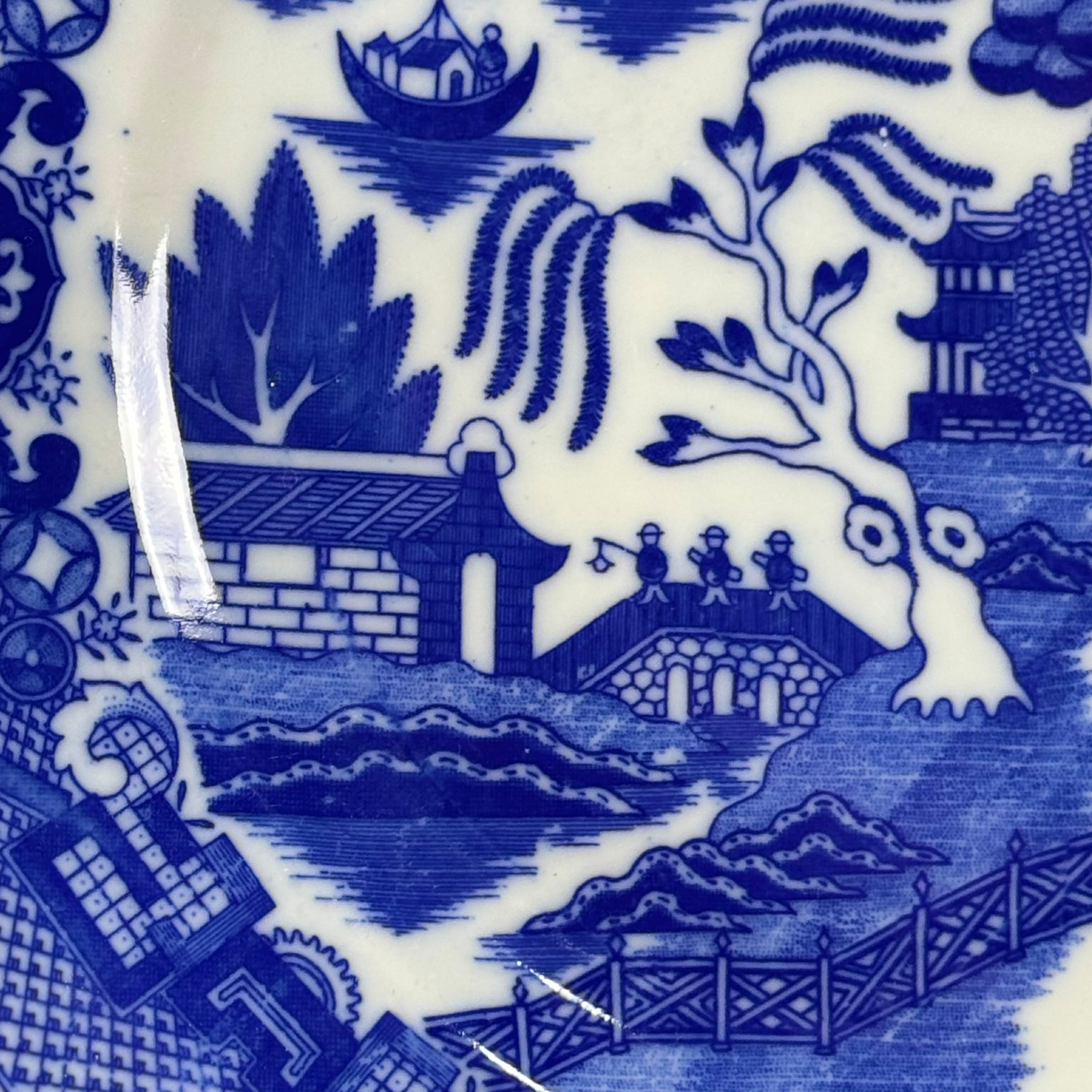 Blue and white ceramic tile with intricate design of a zebra and landscape