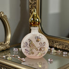 Vintage Art Deco frosted glass perfume bottle with iridescent partridge design