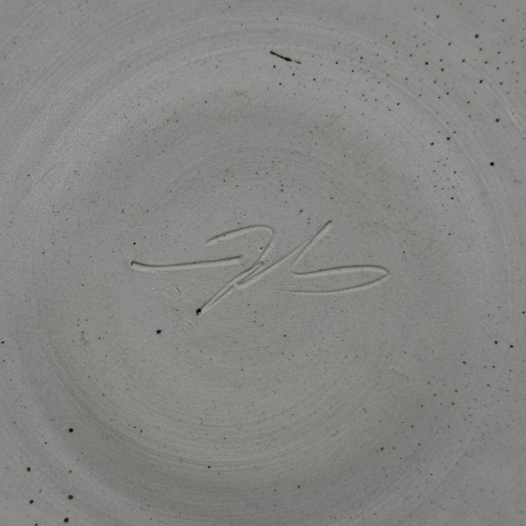 Signature on a textured gray surface