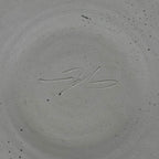 Signature on a textured gray surface