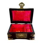 Carved wood jewelry box with ornate brass clasp and jade medallion