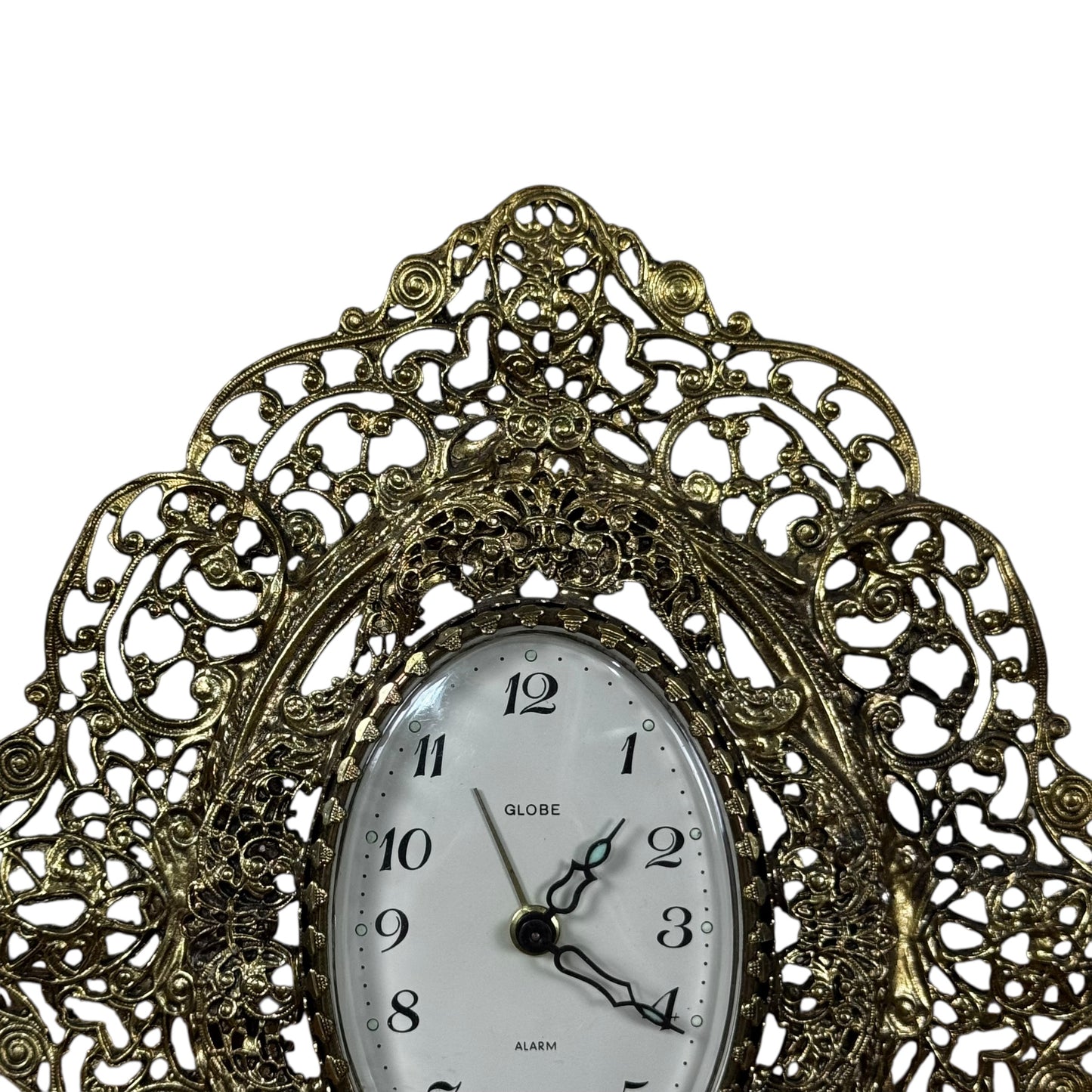 Gold tone filigree mantel clock with oval dial vintage decor