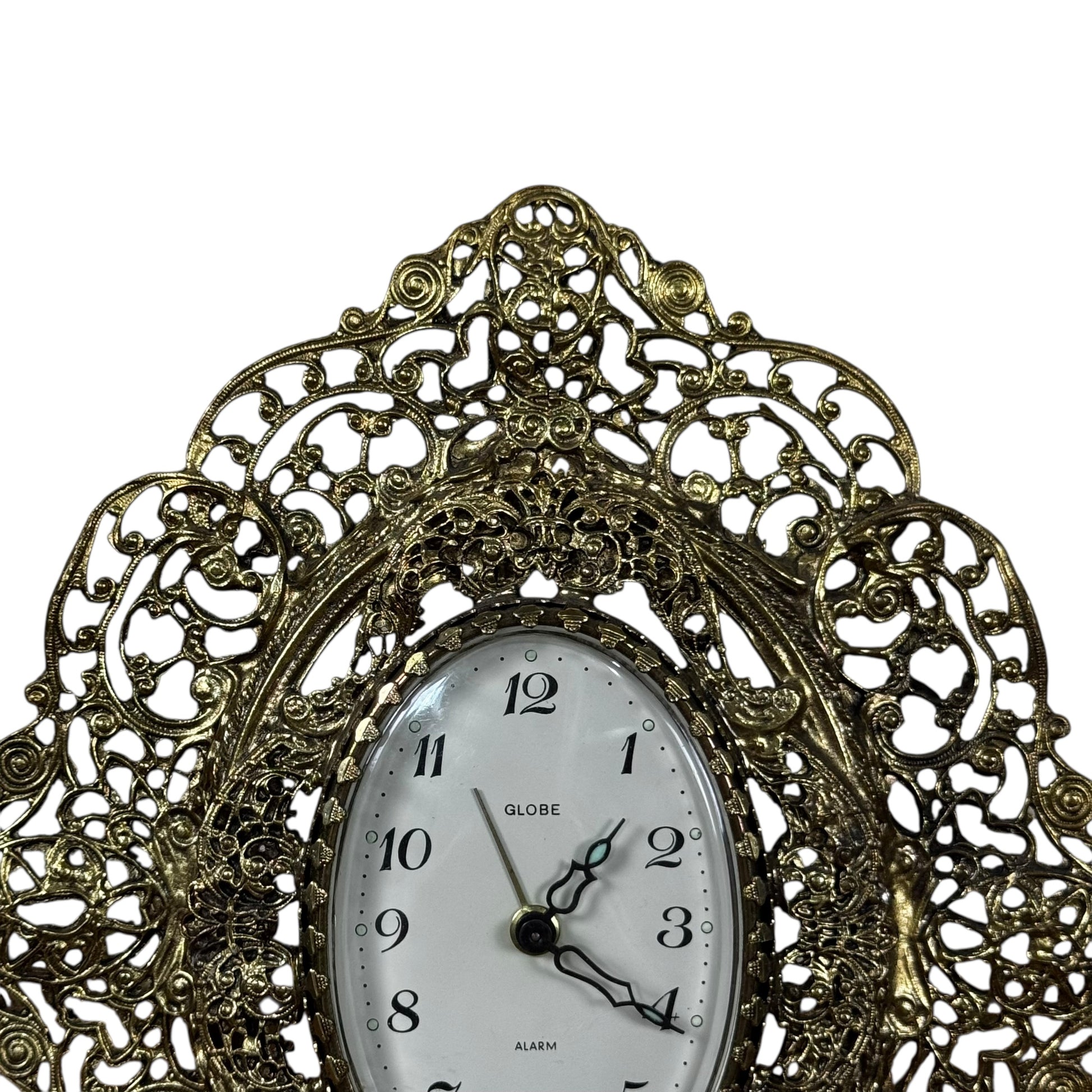 Gold tone filigree mantel clock with oval dial vintage decor