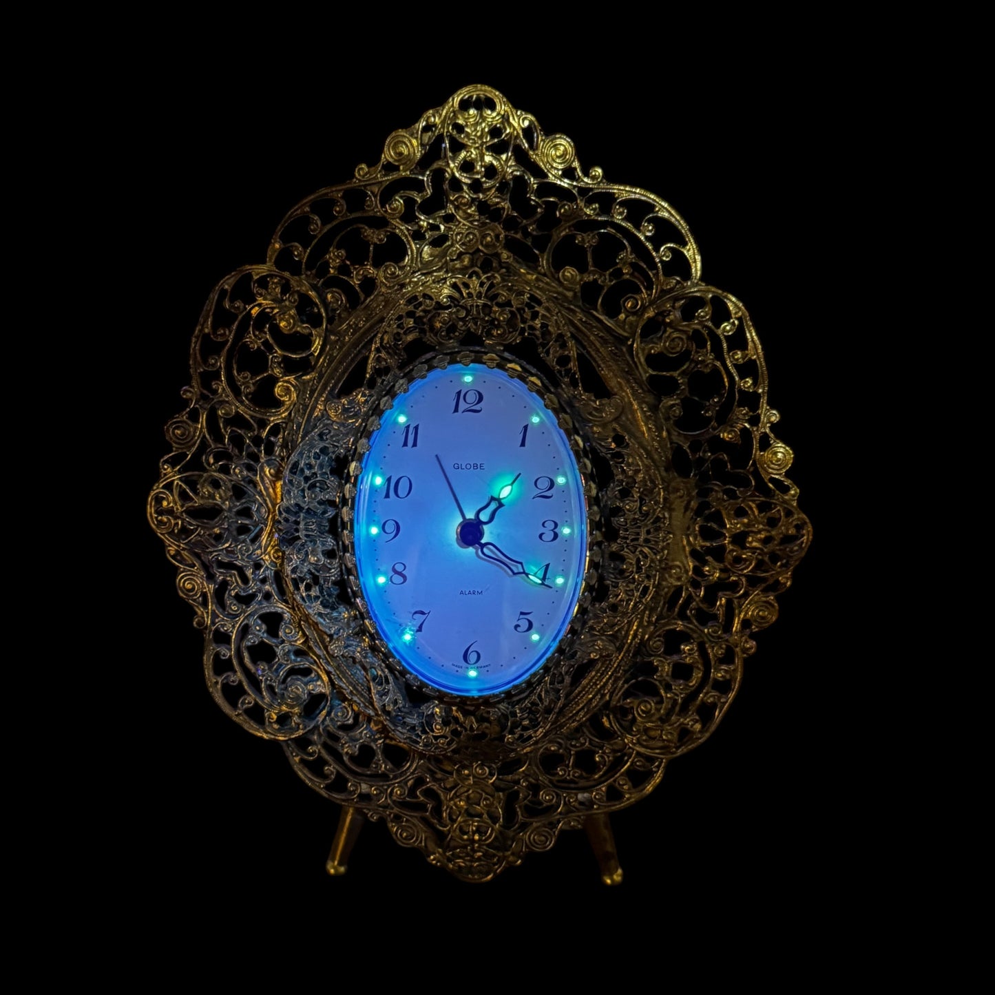 Ornate vintage desk clock with intricate brass scrollwork