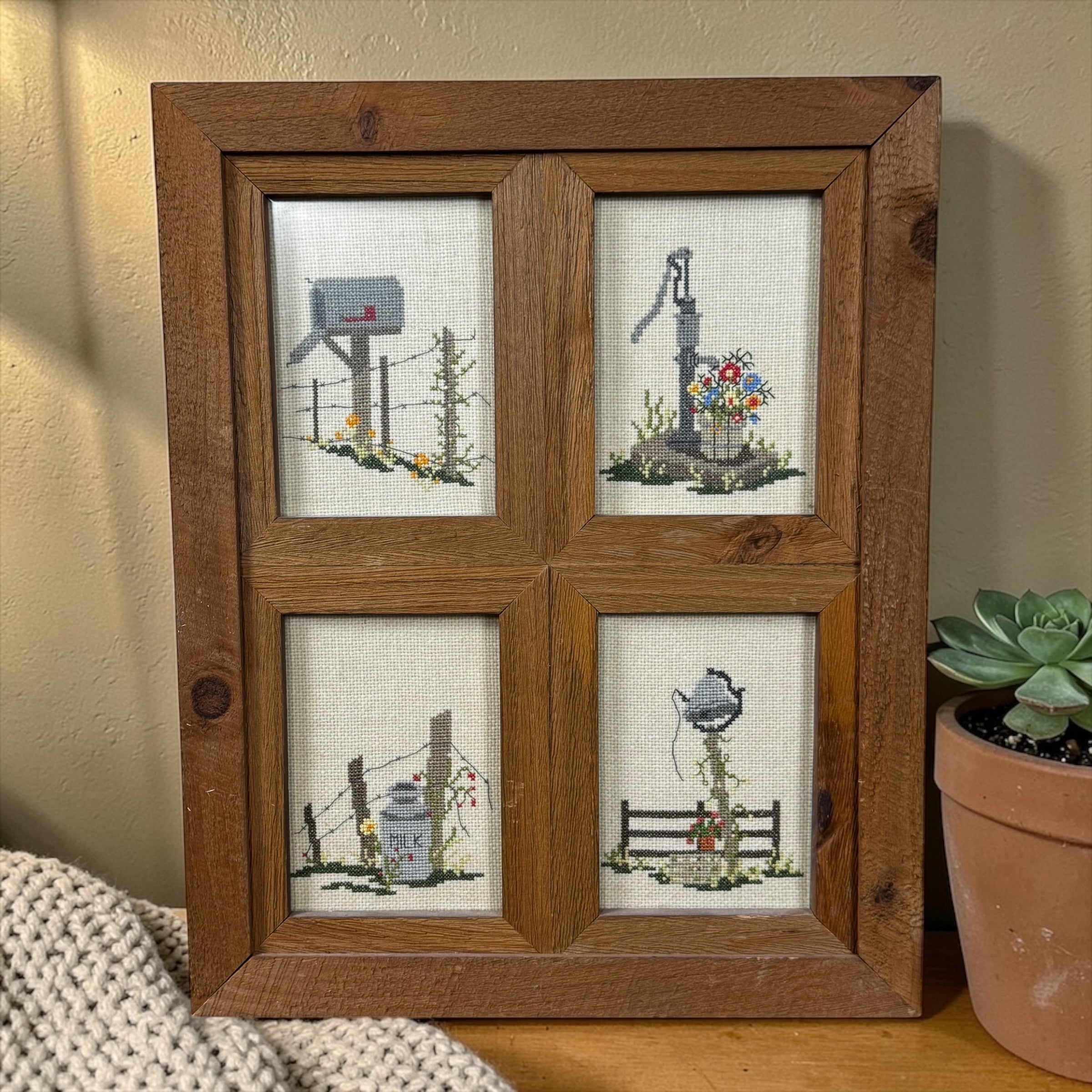 Vintage hand stitched cross stitch sampler in rustic wood window frame farmhouse decor