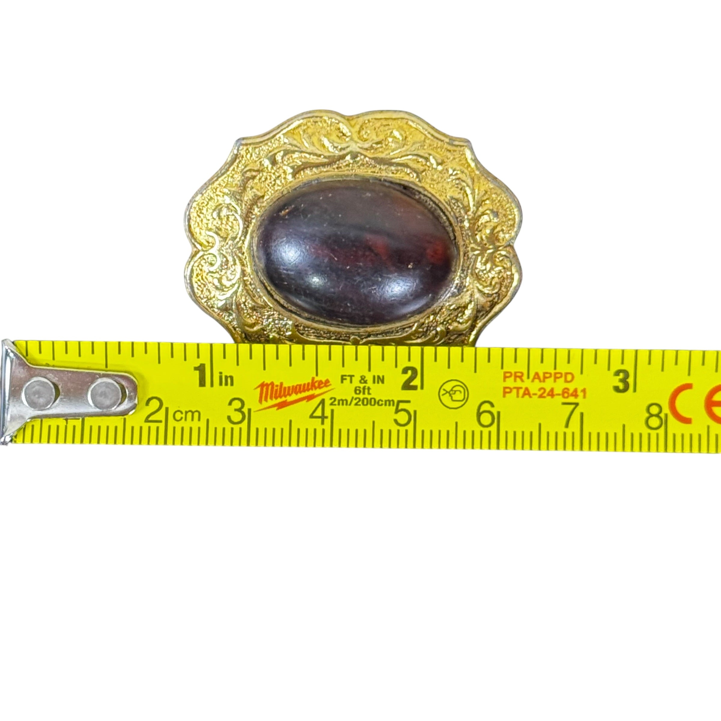 Vintage gold tone jewelry brooch with oval cabochon stone