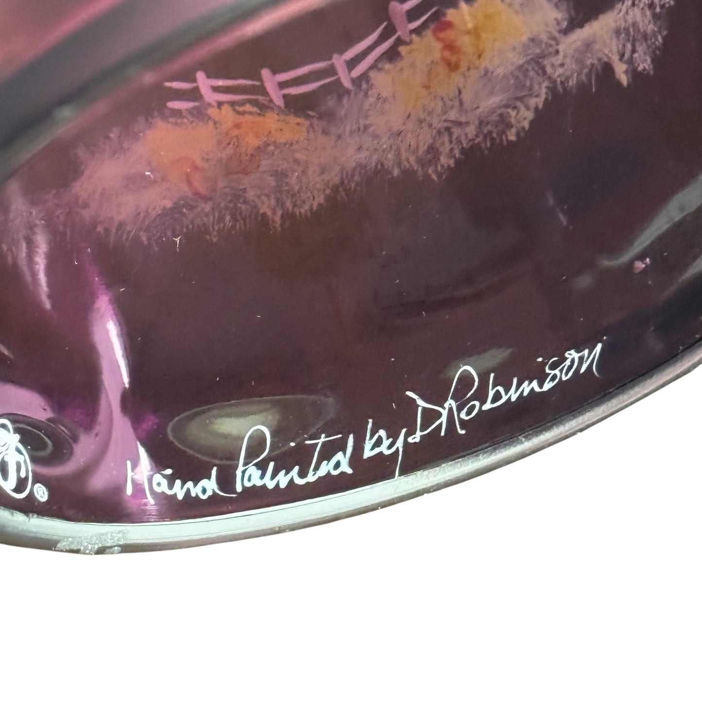 Close-up of a hand-painted drum head with 'Hand Painted by Robinson' signature.
